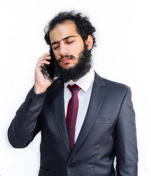 Muslim man wearing tuxedo and talking on the phone