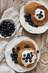 Healthy breakfast concept. Oatmeal pancakes topped with yogurt and blueberries.