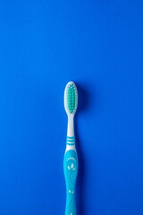 Toothbrush on a blue background. Blue toothbrush. Oral health concept. Photo above