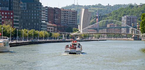 Boat surfing the estuary of Bilbao.