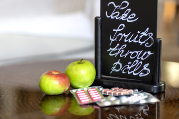 Pills and fruits on table, take care of your body and live healthy