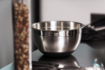 Bowl with pepperbox at kitchen table. Closeup kitchenware at kitchen.
