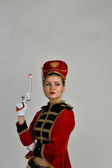 Fototapeta premium beautiful girl in an old hussar costume and in black boots and with a gun