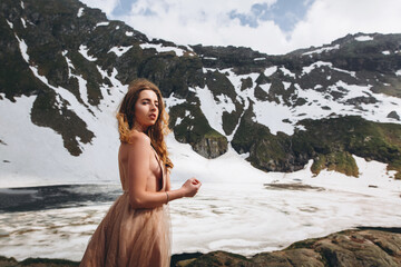 Beautiful bride in a wedding dress on the top of the salt mountains. A stunning young bride with curly hair . Wedding day. . Beautiful portrait of the bride without the groom.