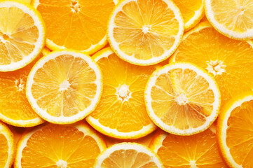 Top view of juicy and yummy slices of orange and lemon background. Healthy fresh food. Place for text or creative design, flat lay. Source of vitamin C. Fresh citrus products concept