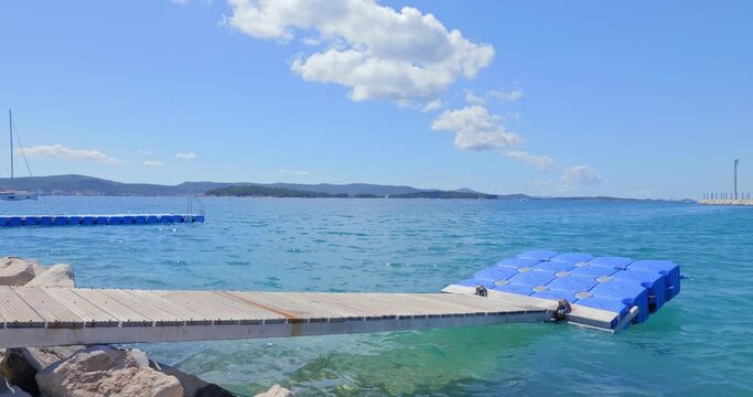 The pontoon floats on the rocky shore of the Adriatic Sea near Biograd na Moru.
