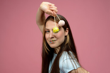 young european woman playes cake pops