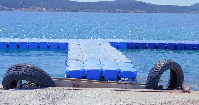 The pontoon floats on the rocky shore of the Adriatic Sea near Biograd na Moru.

