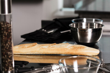 Bread at kitchen restaurant. Closeup french bread with kitchenware. French