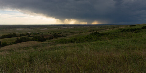 Rain in the distance during sunset over the grasslands in South Dakota