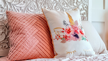 Panorama Fluffy pillows against decorative headboard of single bed against panelled wall