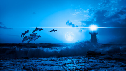 Group of dolphins jumping on the water - Night sky with lighthouse, in the background amazing blue moon in the clouds  "Elements of this image furnished by NASA © muratart