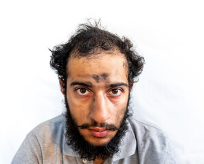 Arabic man with coal on his face having a bad day