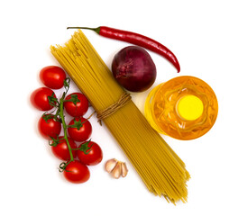 on a white background vegetable oil, spaghetti tomatoes, onion garlic, pepper. ingredients for the preparation of dinner