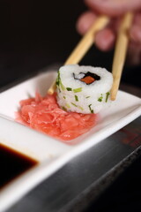 Chopsticks holding sushi