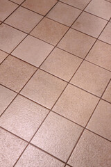 Brown floor ceramic tiles texture. Brown floor tiles. Closeup.