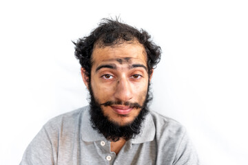 Arabic man with coal on his face having a bad day