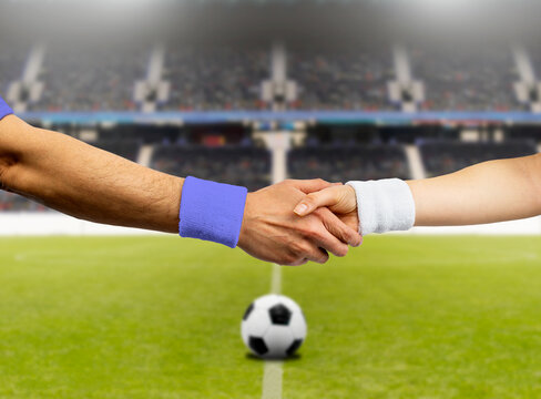 Cropped image of soccer player doing handshake at stadium