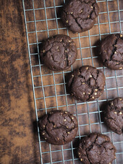 Top view chocolate cookies with almond on brown background