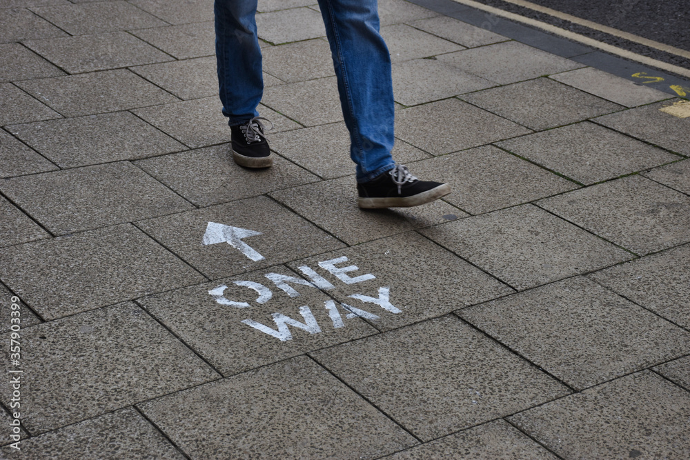 Wall mural oxford, uk- 06 13 2020: oxford introduces social distancing to the city centre streets. here a perso