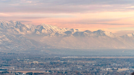 Panorama Stunning Wasatch Mountains and Utah Valley with houses dusted with winter snow