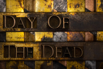 Day Of The Dead text formed with real authentic typeset letters on vintage textured silver grunge copper and gold background