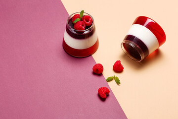 Jelly berries with raspberries in a glass cup on a colorful background