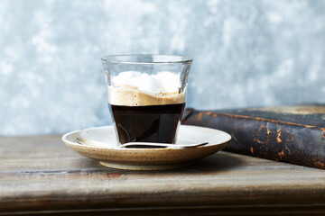 Coffee with milk on rustic wooden background.