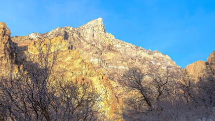 Panorama Trail on a snowy mountain overlooking a steep rocky peak in Provo Canyon Utah