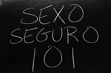 The words Sexo Seguro 101 on a blackboard in chalk.  Translation: Safe Sex 101