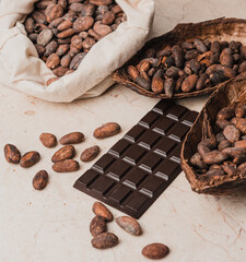 Dark natural chocolate and cocoa beans on the table. Chocolate production concept