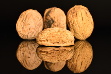 Ripe tasty, organic walnut, close-up, on a black background.