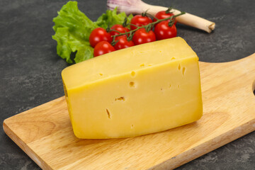 Hard yellow tasty cheese brick