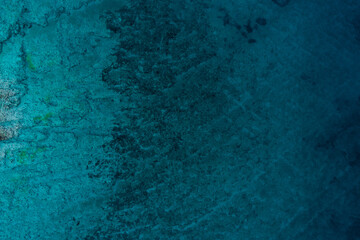 Top down view of a rocky sea texture with clear blue water