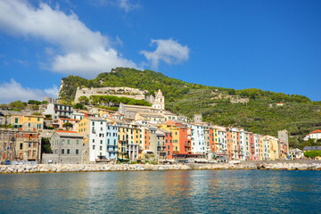 Fototapeta na wymiar The colorful village of Portovenere Italy, on the Ligurian coast near the Cinque Terre. View from the sea on a summer day.