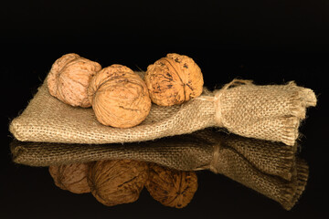 Ripe tasty, organic walnut, close-up, on a black background.