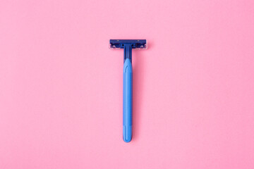 one disposable razor blade on  pink background