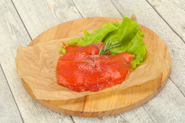Sliced salmon fillet served rosemary