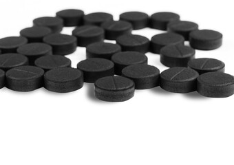 Black carbon tablets isolated on white background