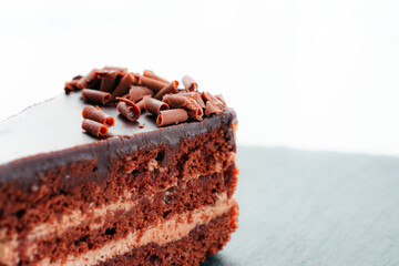 a piece of chocolate cake with a fork on a black stone. the view from the top.the concept menu