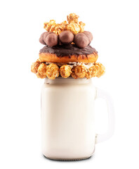 Extreme milkshake with donut, caramel popcorn and chocolate candies isolated on white background with clipping path
