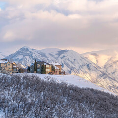 Square frame Picturesque Wasatch Mountains view with houses on a snowy setting in winter