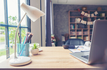 Business computer office desk with desktop laptop, notebook, pen and annual, summary report place on wooden table, working space at home. Business executive office table concept.