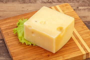 Emmental cheese over wooden board