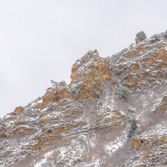 Square crop Rocky mountain terrain of Provo Canyon in Utah with cloud filled sky background