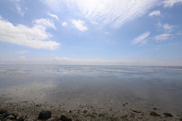Beautiful panoramic view over the Sea at very low tide with a blue sky.