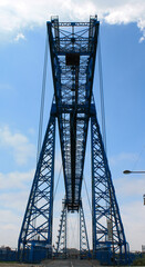 Fototapeta na wymiar The Tees Transporter Bridge at Middlesbrough. Showing the gondola bridge and the surrounding dock area.