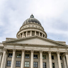 Square frame Utah State Capital building dome and stairs leading to the pedimented entrance