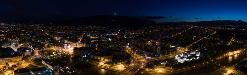 Obraz premium Large aerial panoramic shot of Skopje, North Macedonia at night. Night panorama of the city center of Skopje
