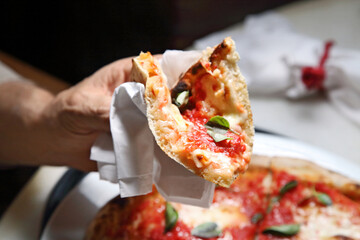 Neapolitan pizza on the plate, showing how to eat.